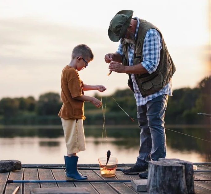 grandpa and grandson catching a fish